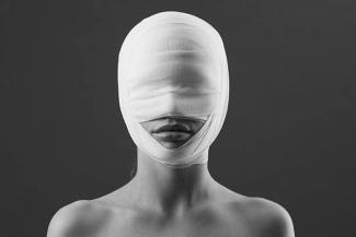 Woman with bandaged face
